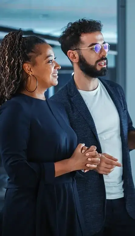 Business professionals discussing a project in an office.